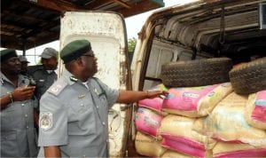 Customs Area Comptroller Oyo/Osun Area Command, Mr Temitope Ogunkua showing newsmen some bags of  rice seized from smugglers in Ibadan, recently