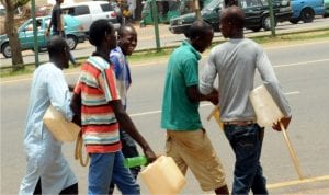 Ilegal petrol sellers at the NNPC Mega Station in Abuja last Saturday.