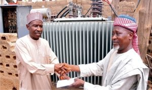 Representative of  Senator Shehu Sani, Alhaji Suleiman Ahmed (left), presenting 500kva transfomer  to the District Head of Badarawa Majalisa Kwaru, Alhaji Abdulhameed Giwa in Kaduna, recently.