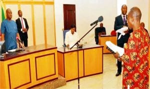 Governor Nyesom Wike of Rivers (left) Swearing-in-Commissioner of Rivers Independent Electoral Commission, (RSIEC), Mr Ugbana Isaruk in Port Harcourt, recently.