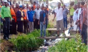 State Commissioner for Environment, Prof. Roseline Konya (3rd left), inspecting the Amadi-Ama gutter covered with dirts, during one of the monthly Sanitation exercises in Port Harcourt. Photo: Chris Monyanaga