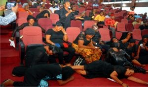 Widows from Tai Local Government Area of Rivers State on the floor crying for their husbands and children killed by soldiers at Tai during the March 19 rerun elections in Rivers State .Photo: Chris Monyanaga