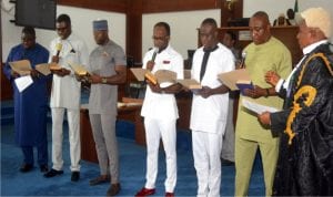 Clerk of the Rivers State House of Assembly, Mr Stanford Oba (right), swearing-in the newly elected members of the Rivers State House of Assembly, yesterday 