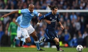 Manchester City captain (left), in a tussle with Gareth Bale in their first semi-final march at the Etihad Stadium, yesterday