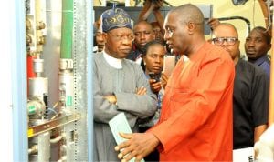 Minister for Information, Mr Lai Mohammed (left) with the General Manager, Integrated TV Service, Mr Rotimi  Salam, during the minister's inspection of NTA  digitisation  facilities in Jos recently.