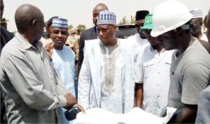 Minister of Defence,  Retired  Brig.-Gen.  Mansur Dan'Ali (middle), being shown the master plan of the construction of New Army Barrack in Gusau Zamfara State last Saturday 