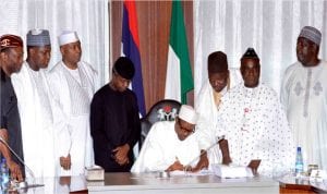 President Muhammadu Buhari (4th right), signing the 2016 Appropriation Bill into Law at the Presidential Villa in Abuja on Friday. With him are from left: Minister of Budget and National Planing, Sen. Udoma Udo Udoma, Speaker, House of Representatives, Yakubu Dogara, Senate President Bukola Saraki, Vice-President Yemi Osinbajo, Senior Special Assistant to the President on National Assembly Matters (House of Representative) Abdulrahman Sumaila Kawu, Senior Special Assistant to the President on National Assembly Matters (Senate) Sen. Ita Enang and Secretary to the Government of the Federation, Mr David Lawal