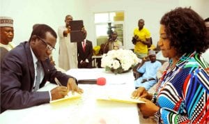 Governor Simon Lalong of Plateau State left), signing the 2016 Appropriation Bill into law in Jos on Tuesday. With him is the Plateau State Commissioner for Finance, Tamwakat Wali