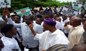 Executive Secretary, National Universities Commission, Prof. Julius Okojie (middle), addressing members of the National Association of Nigerian Students (Nans), protesting over sacked Vice Chancellors, at the entrance of the Federal Ministry of Education in Abuja yesterday
