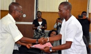 Outgoing Rivers State Commissioner for Works, Engr Kelvin Kinikanwo Wachukwu (left), handing over office documents to the new Commissioner, Hon Bethuel Iheanyichukwu Harrison in his office in Port Harcourt, on Tuesday.