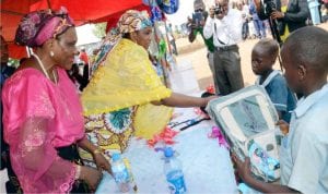 Permanent Secretary, Federal Ministry of Women Affairs and Social Development, Hajiya Binta Bello (right), presenting prizes to the best dancers, during the ministry’s party with children from the Internally Displaced Persons (IDPs) camp, as part of activities for the 2016 Children’s Day celebration at New Kichingoro in Abuja on Wednesday. With her is the Ministry’s Director of Child Development, Mrs Georgette Azogu (left).